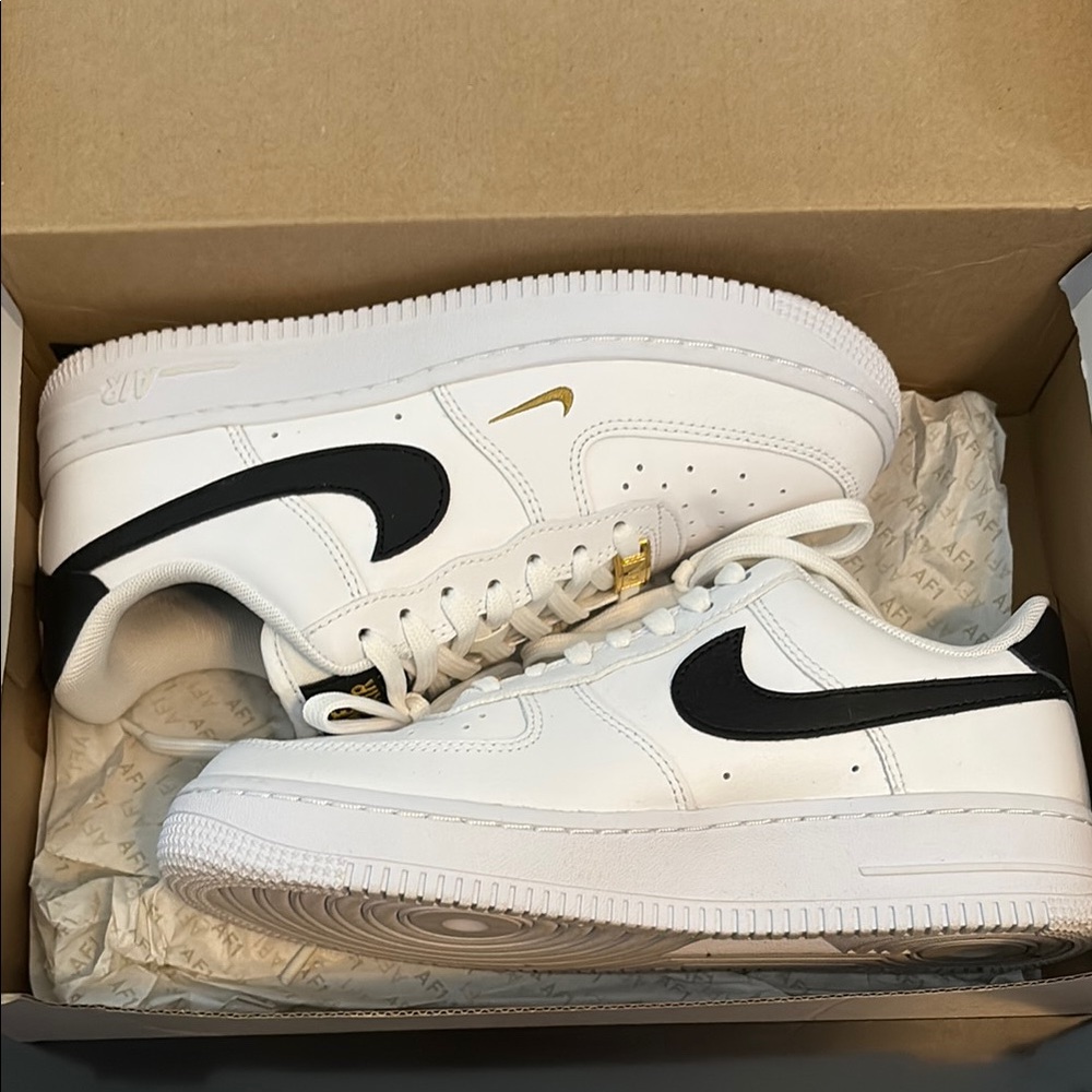 **SOLD**
Nike White Air Force One Sneakers with Black and Gold Details